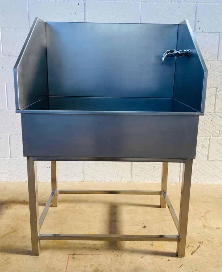 A stainless steel freestandinng sink which was designed as a dog bath