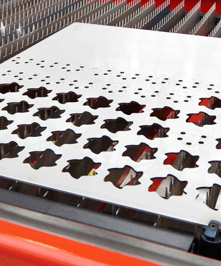 A laser cutting machine cutting shapes into a sheet of steel