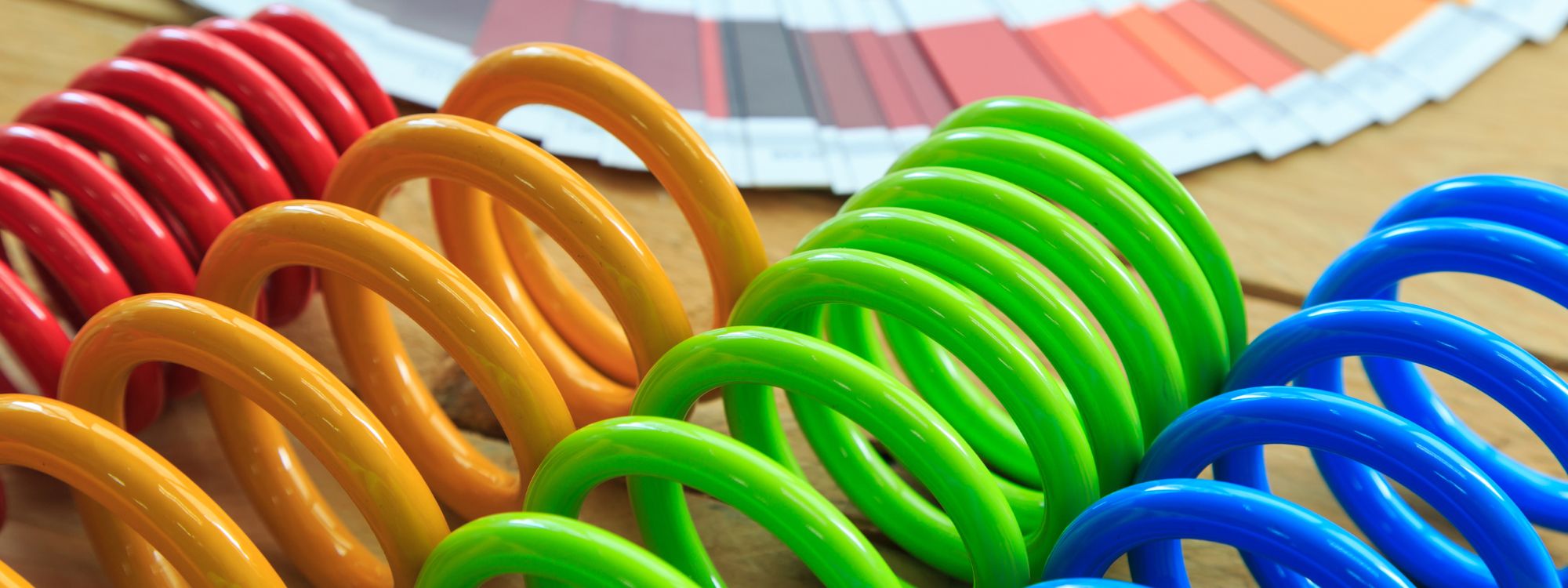 Red, yellow, green and blue powder coated springs.